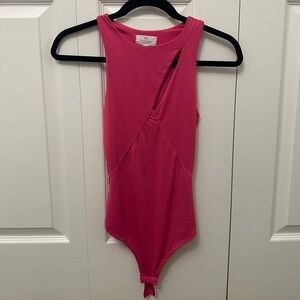 Pink Sleeveless Bodysuit with cut out detail in the front